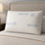 Almohada viscoelástica Visco Fresh de Dorminoite sobre cama tapizada en dormitorio con luz cálida
